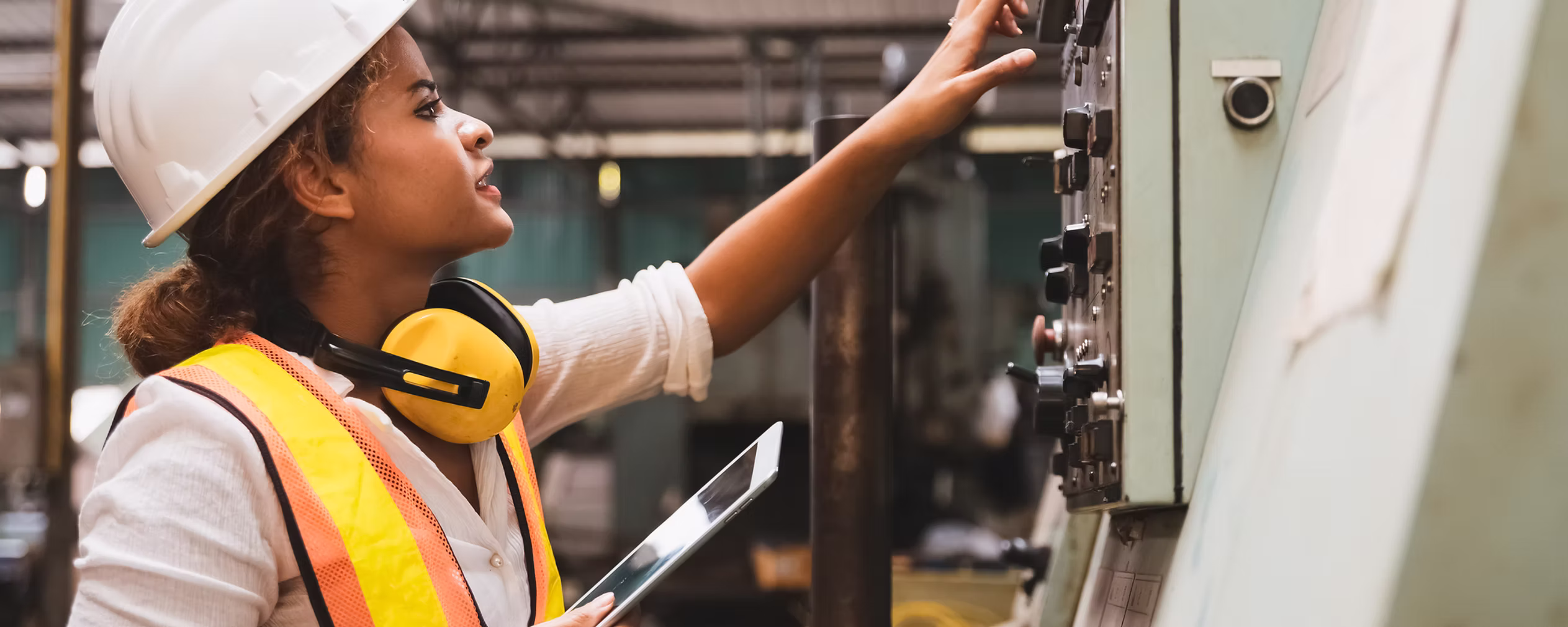 Worker using EHSdesk near industrial equipment